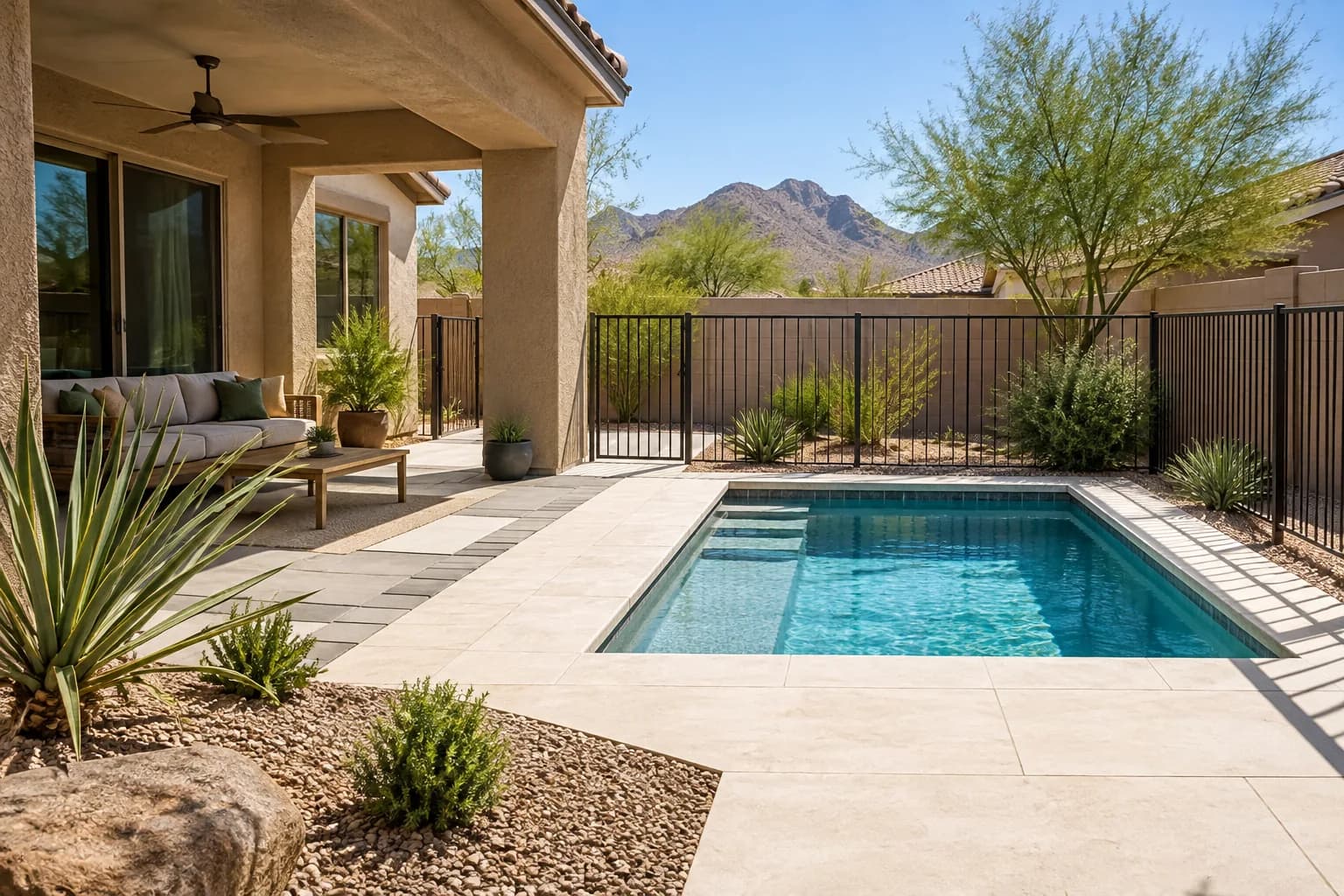 Western backyard plunge pool concept with shade, pale deck, safety barrier, and water-conscious planting